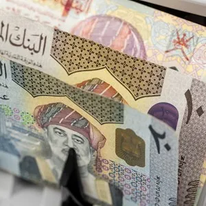 Oman money. Money counting machine with Omani rials. Business concept.