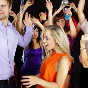 A group of young beautiful people dancing at a disco