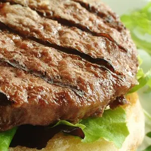 beef burger on bun with lettuce