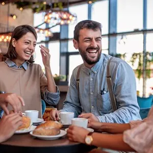 Young friends having a great time in restaurant
