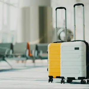 Two suitcases in an empty airport hall