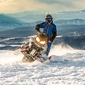 Rider on the snowmobile in the mountains