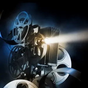 Cinema background with movie projector and film reels on a dark background