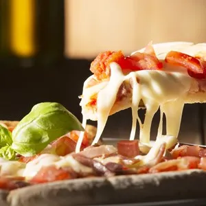 Pizza with bacon on a wooden table