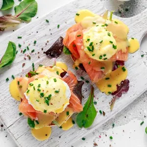 Eggs Benedict on english muffin with smoked salmon