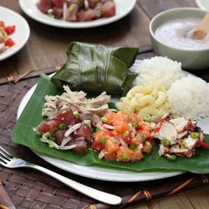 Hawaiian traditional plate with ahi poke, lomi lomi salmon, tako poke, kalua pork, poi and lau lau