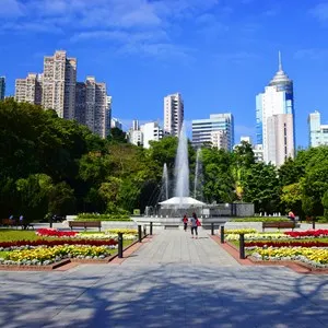 A colorful view towards the fountain and trees in the Hong Kong Zoological And Botanical Gardens.