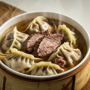 A bowl of dumpling soup with meat