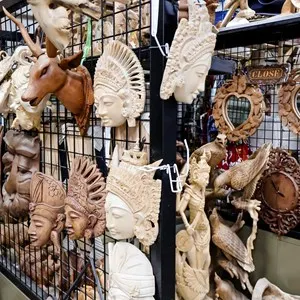 Various handmade wooden statues and carvings at Sukawati Art Market, showcasing intricate craftsmanship and traditional Balinese designs. Culture, art, travel, and souvenirs for tourist