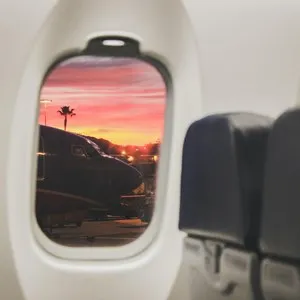 plane seats and window in sunset at airport