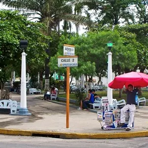 street signs in Costa Rica next to a park