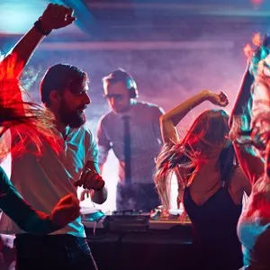 Group of dancing friends enjoying night party