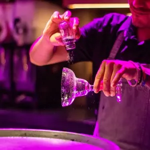 bartender salting the rim of a margarita glass