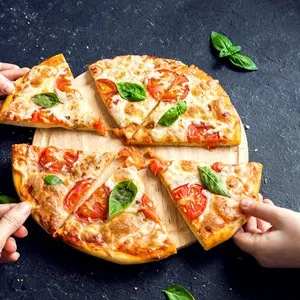 People Hands Taking Slices Of Pizza Margherita. Pizza Margarita and Hands close up over black background.