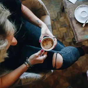 woman in a cafe holding a cup