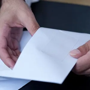 Businessman hands opening an envelpoe