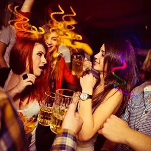 People in night club. Dancing, drinking and having fun