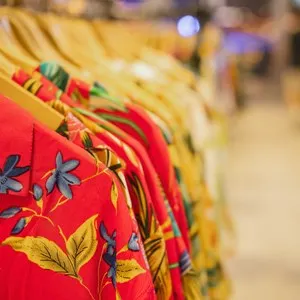 shirt and clothes for aloha summer hanging on a shelf in a designer clothes store