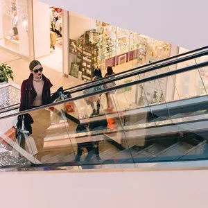woman on a escalator in a shopping mall, Barcelona