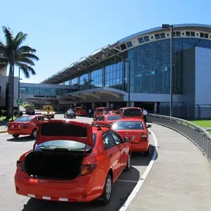 line of red taxis next to Juan Santamaría International airport