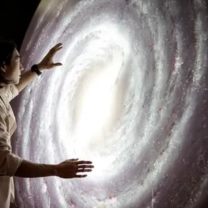 Man experiencing the universe at a planetarium