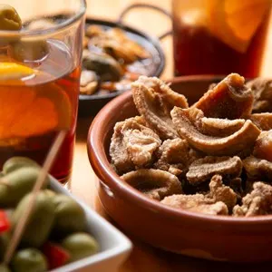 Table with Spanish tapas and vermouth at noon in a bar in Barcelona.