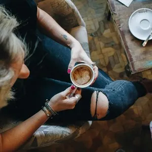 blonde woman drinking coffee