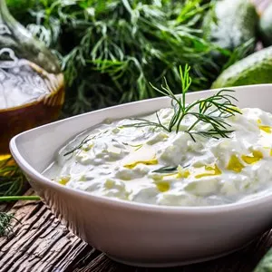 Tzatziki. Traditional greek dip sauce or dressing tzatziki prepared with grated cucumber sour cream yogurt olive oil and fresh dill. Mediterranean cuisine