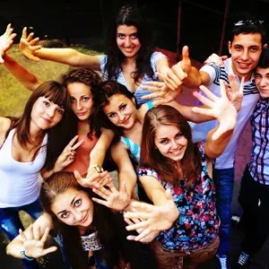 A group of young people dancing at a disco.
