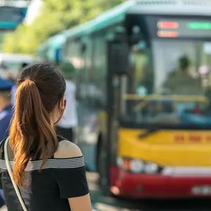 Young girl waiting for bus at bus station in Hanoi, Vietnam