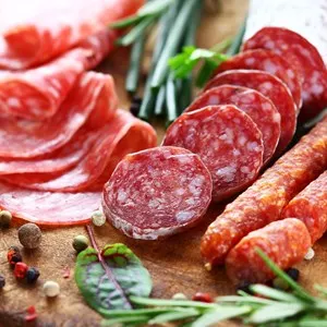 Different Italian ham and salami with herbs