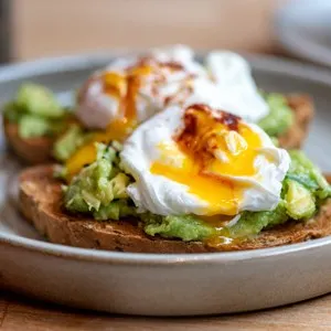 Healthy Breakfast with Wholemeal Bread Toast and Poached Egg with mashed Avocado