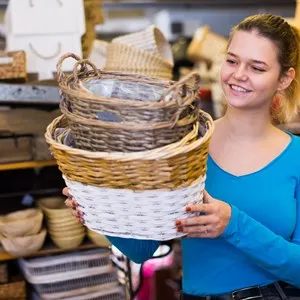 Young woman with wicker furniture