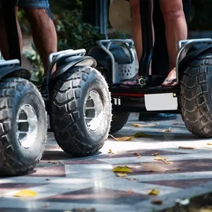 Wheels of electric scooters in the park close up