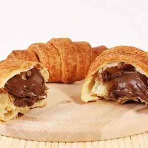 Fresh chocolate croissant on a wood traditional plate