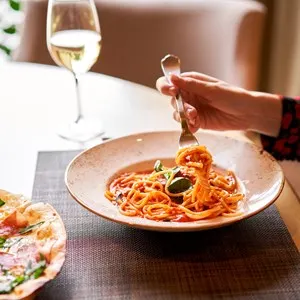 Woman eats Italian pasta at an Italian restaurant