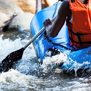 Close-up of young person rafting on the river