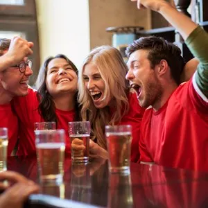 Friends watching a sport game and cheering