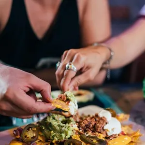 Couple eating nachos at a Mexican restaurant