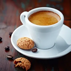 Cup of espresso and biscotti. Cup of coffee with a sweet cookie and coffee beans