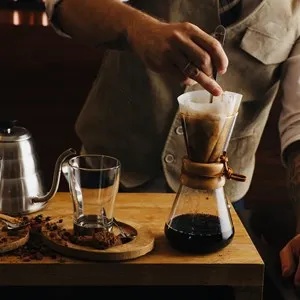 Image of a unrecognizable person making coffee.