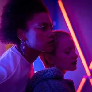 two young women in neon light
